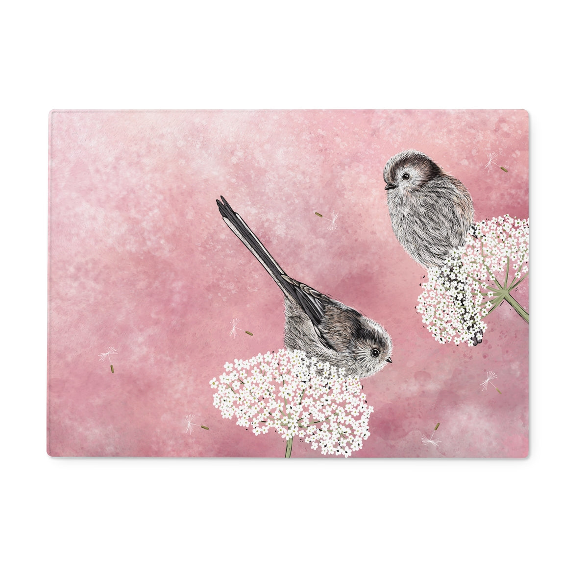 This rectangular long tailed tits tempered glass chopping board design from Fox and Boo depicts two cute long tailed tits balancing on some cow parsley, background is a watercolour berry pink, with floating dandelion puffs.