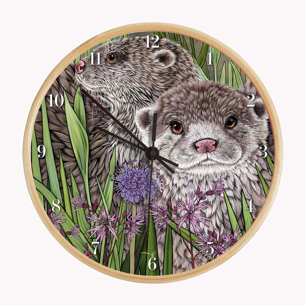 Otter Wall Clock featuring two illustrated otters among rushes and ragged robin flowers on a bamboo frame.