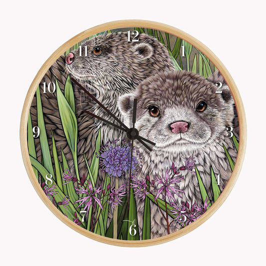 Otter Wall Clock featuring two illustrated otters among rushes and ragged robin flowers on a bamboo frame.