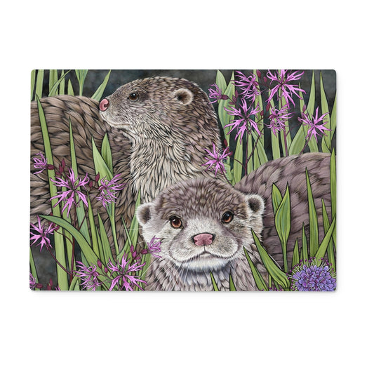 Otters Tempered Glass Chopping Board, Illustration features 2 otters on a dark background, surrounded with rushes, marsh flowers and pink ragged robin.