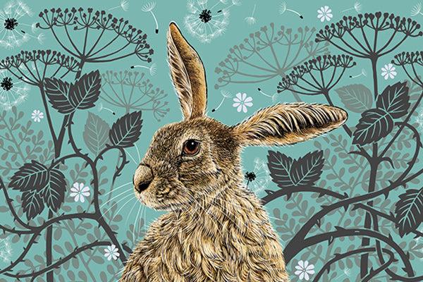 This tea towel design features a hare portrait with one floppy ear, around the hare are stylised brambles, leaves, cow parsley and dandelion puffs, background colour is a vintage aqua.