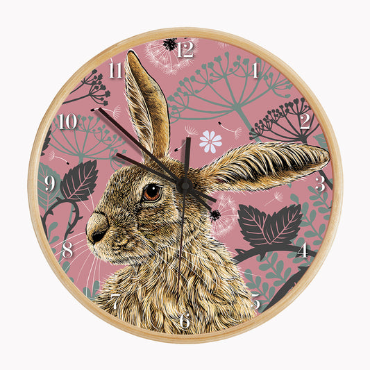 Sustainable hare wall clock - antique rose, hare surrounded by brambles and cow parsley on a pink background