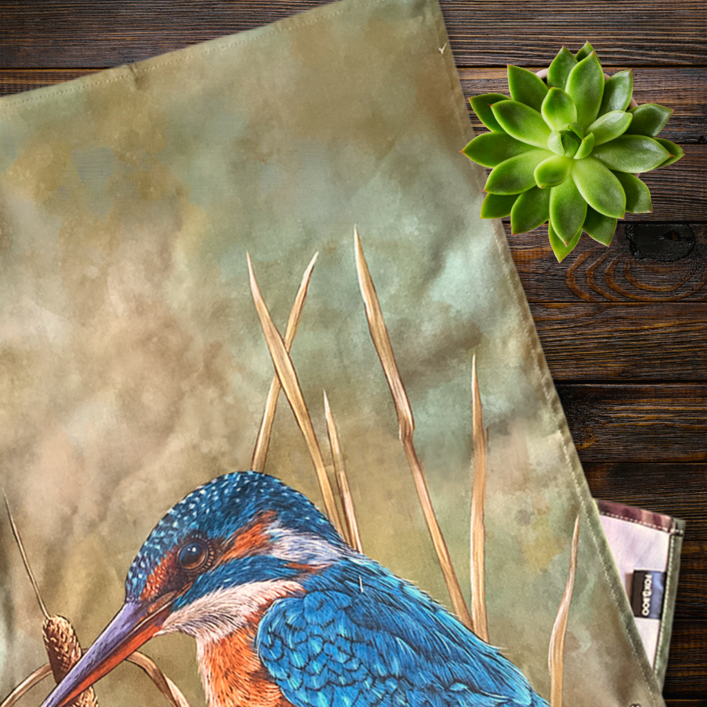 Kingfisher bird design on a tea towel with a wooden background flat lay
