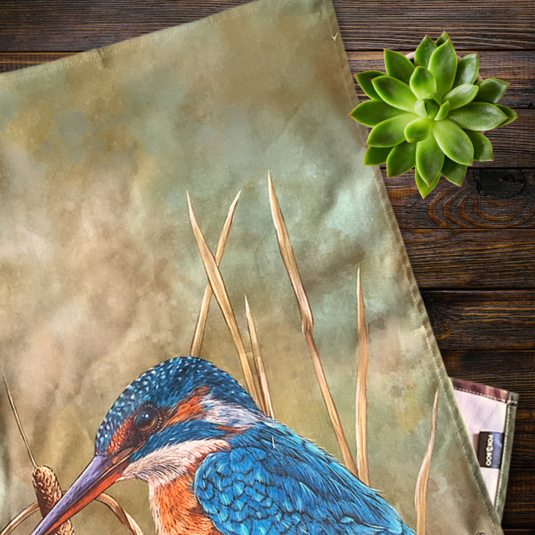 Kingfisher bird design on a tea towel with a wooden background flat lay