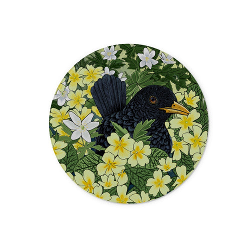 Blackbird and Primrose Glass Worktop Saver, cute blackbird is partially hidden in this design, it is peeping out from behind dozens of yellow primroses and wood sorrel.